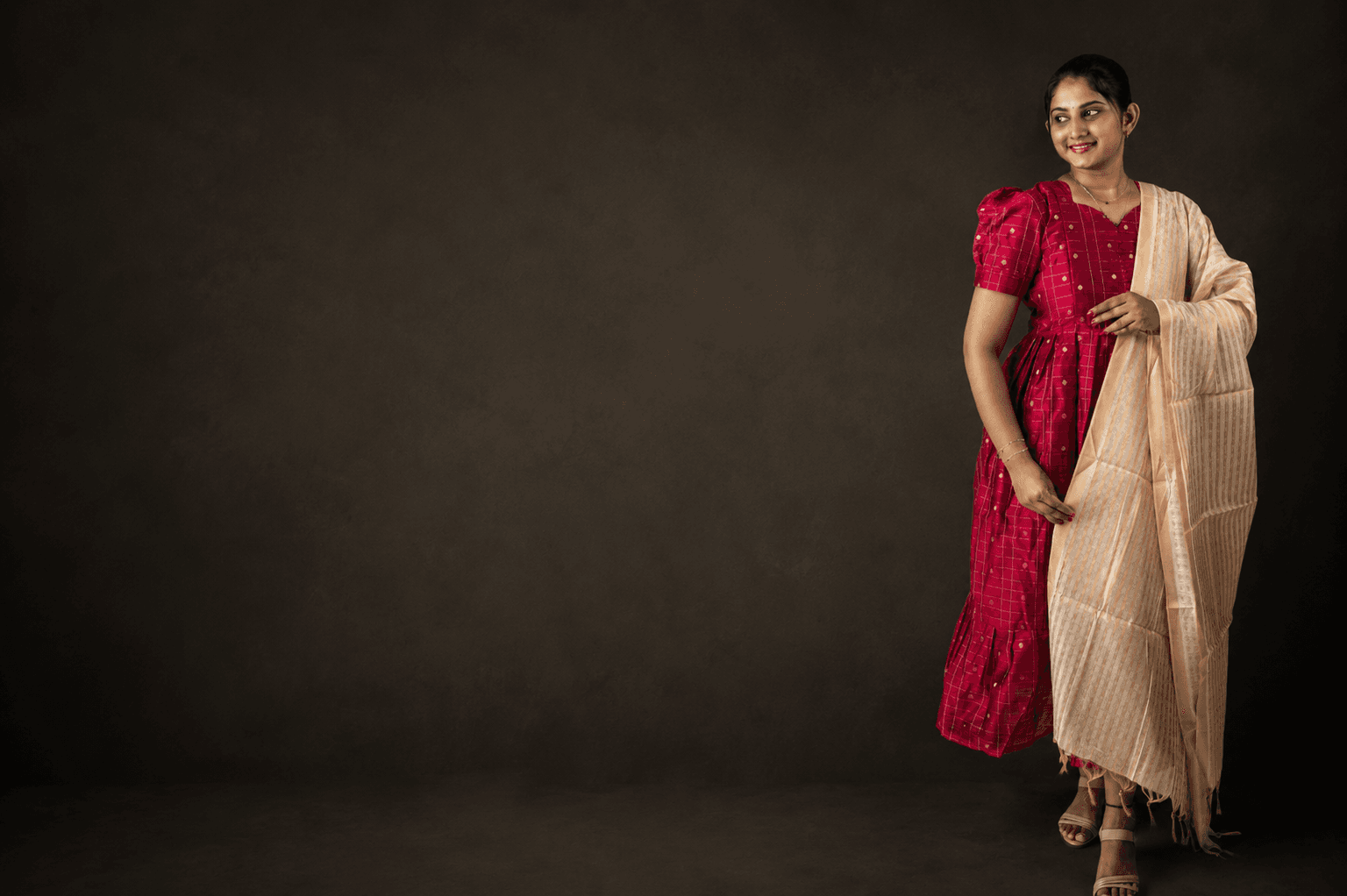 Woman wearing an elegant YEZ BEE festive ethnic red dress with gold dupatta